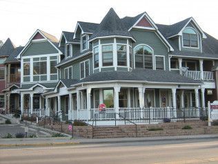 A large house with a lot of windows and porches