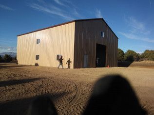 A group of people are walking in front of a large building.