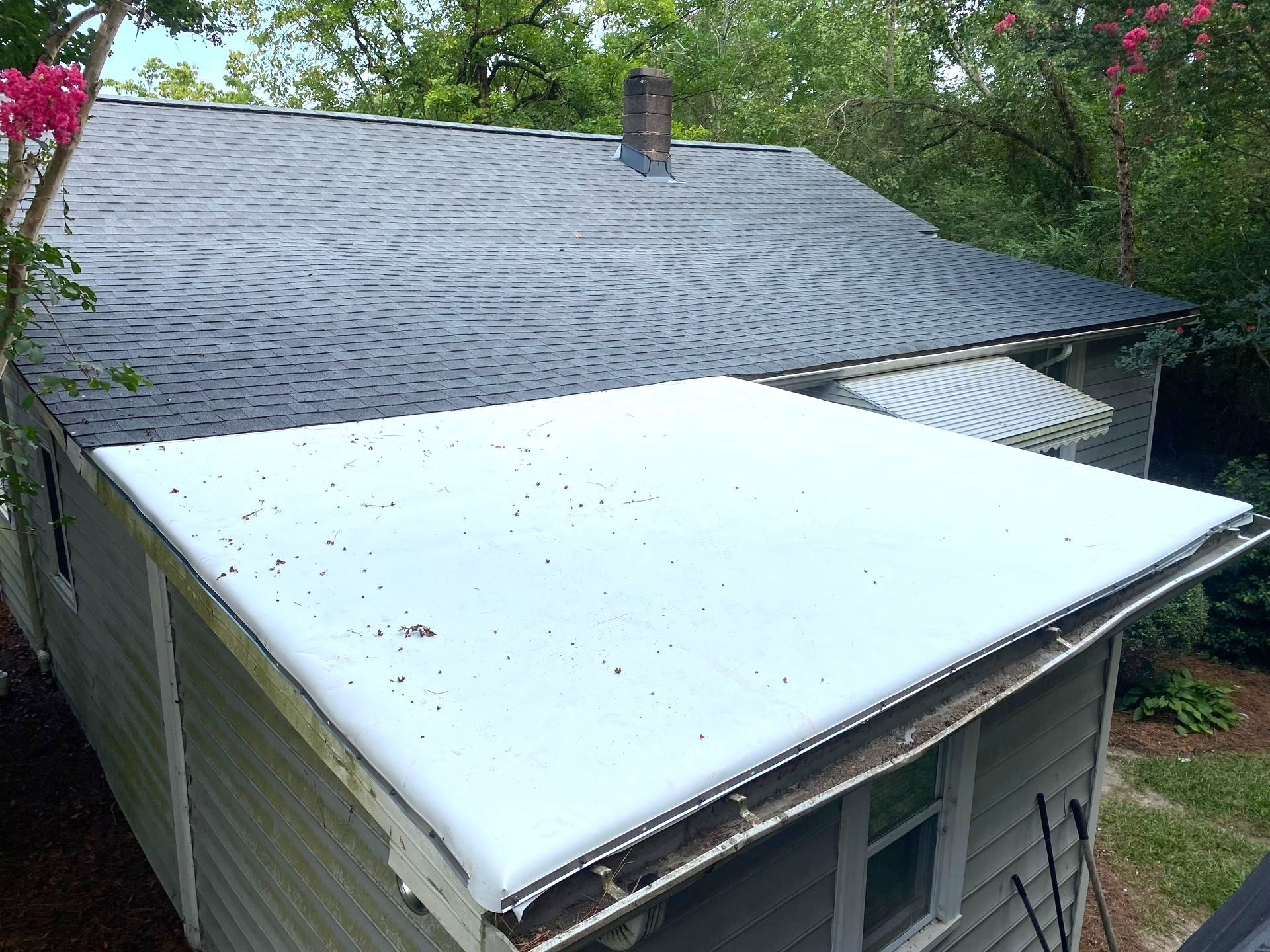 A house with a white roof and a black roof