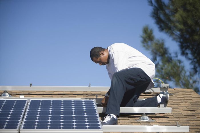worker installing solar panel