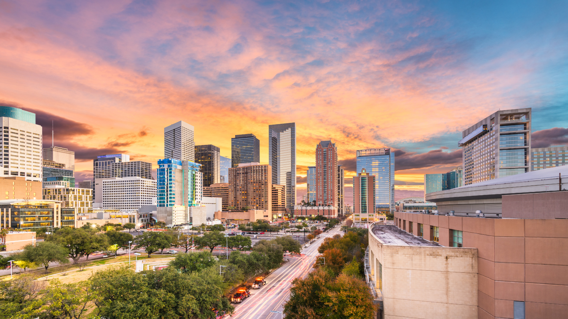 An aerial view of a city skyline at sunset.
