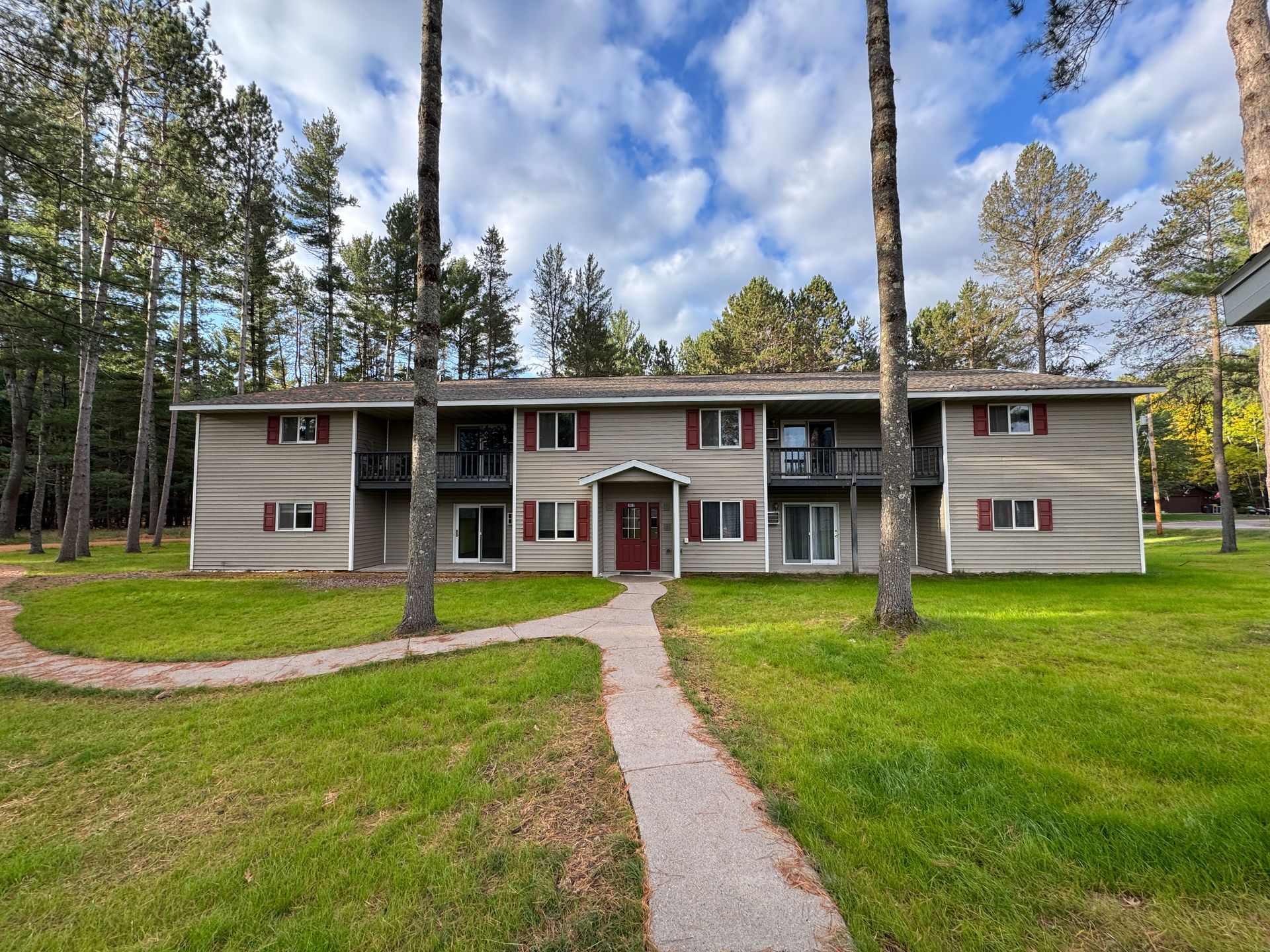 Welcome to Balsam Woods Apartments, a well-maintained, professionally managed community located in the heart of Woodruff, WI. The property consists of three two-story buildings nestled on beautifully kept grounds with expansive green space. Each spacious two-bedroom apartment is designed for comfort, featuring functional layouts and private outdoor space—ground-level units offer patios while second-floor units include private balconies. With detached garages available, on-site storage, and professional management, Balsam Woods offers a quiet and convenient residential setting perfect for enjoying the Northwoods.