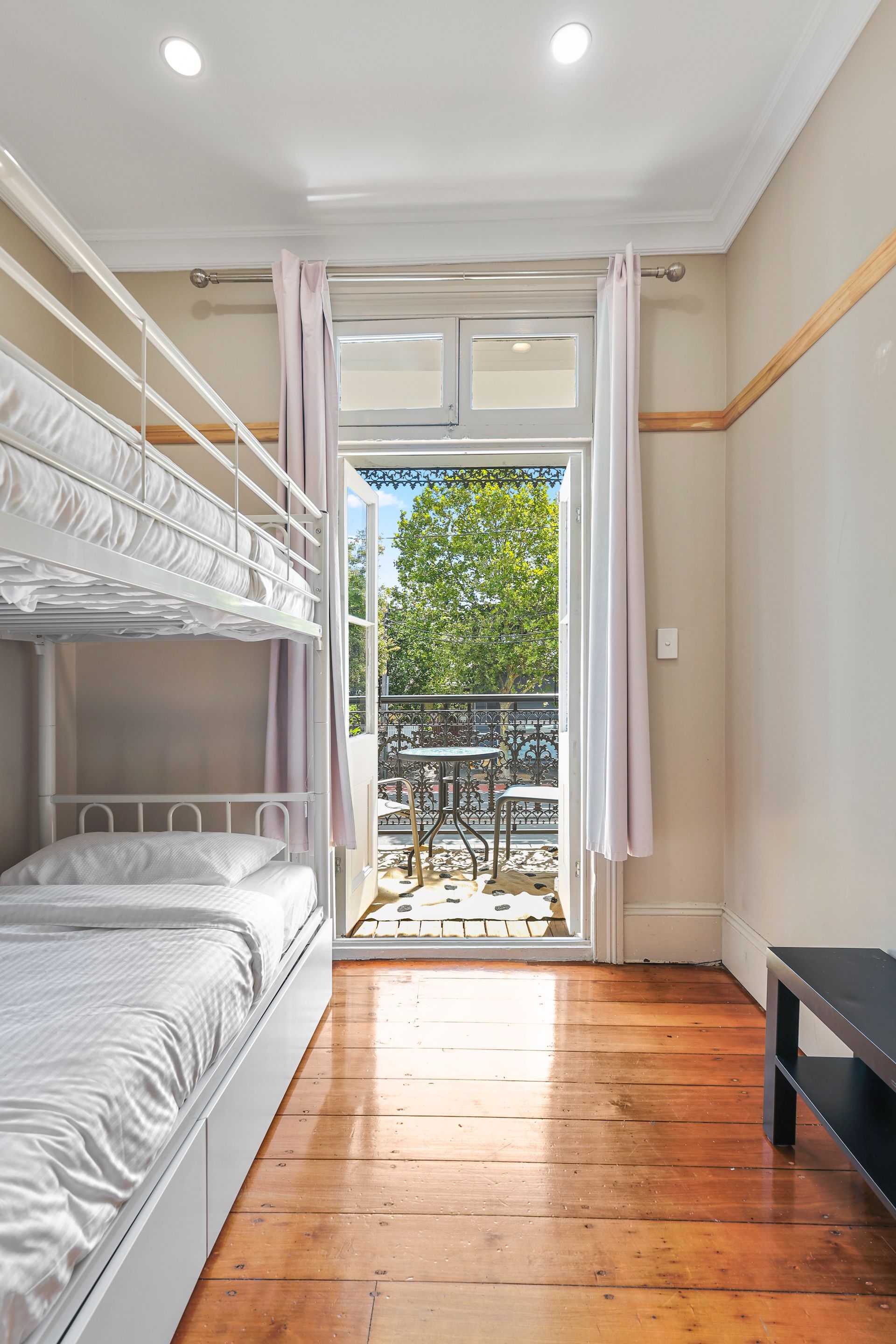 A bedroom with bunk beds and a balcony.