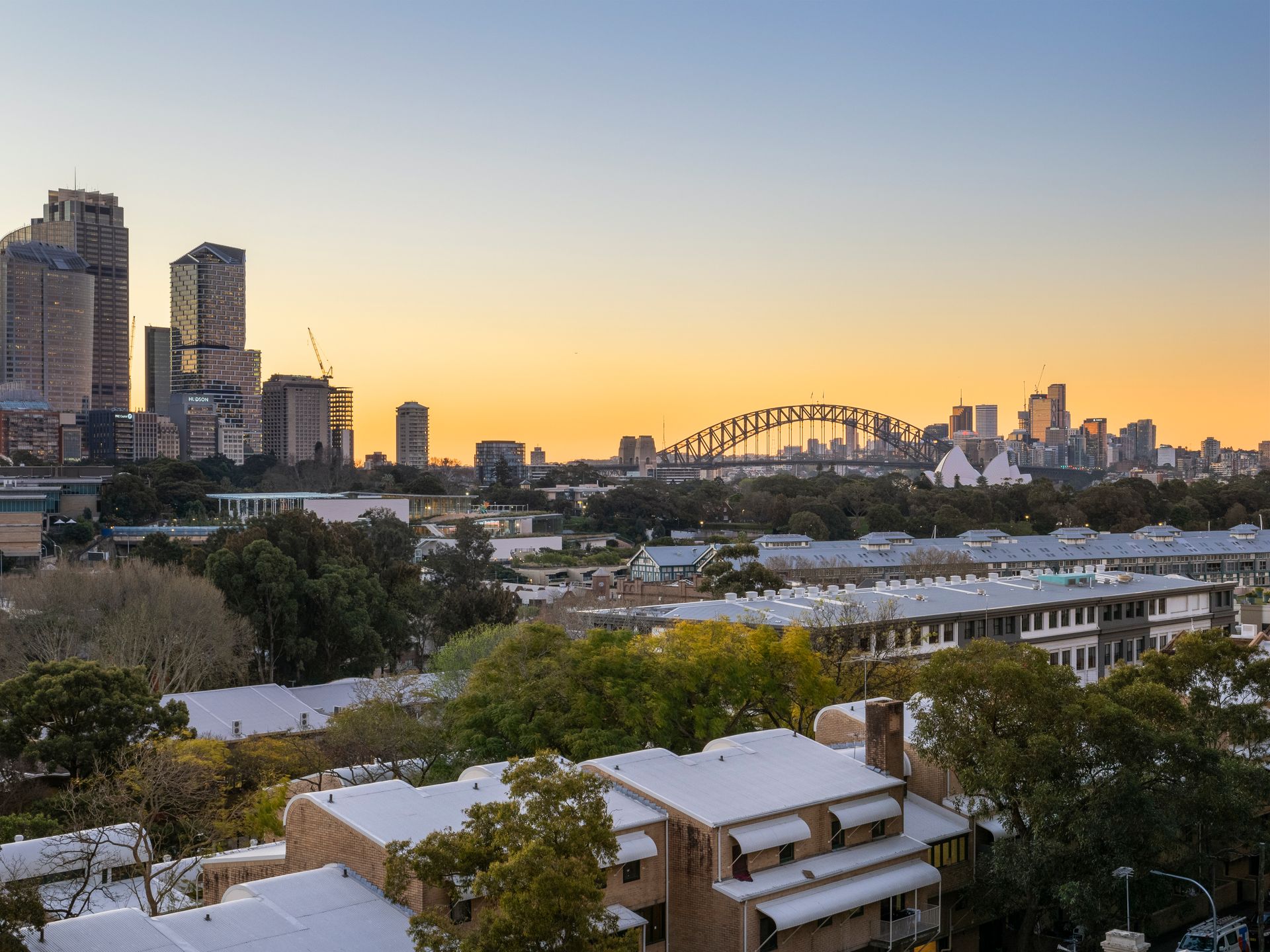 An aerial view of a city with a bridge in the background