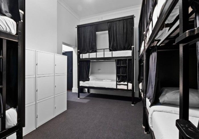 A room with bunk beds and lockers in it