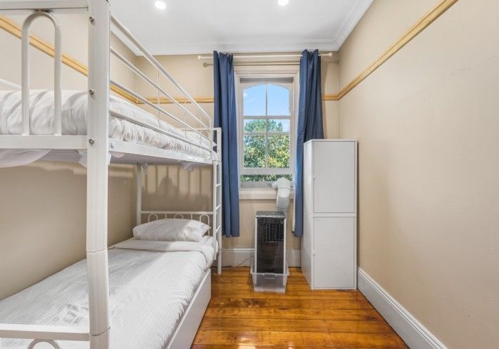A bedroom with bunk beds and a window