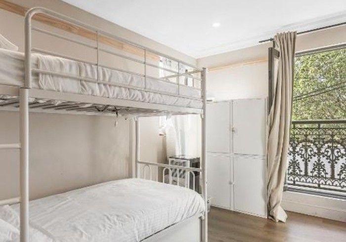 A bedroom with a bunk bed and a single bed.