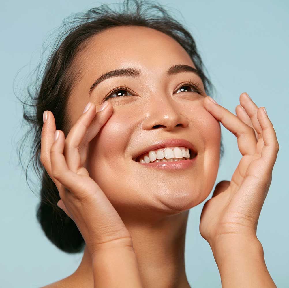 Woman with beauty face touching healthy facial skin portrait