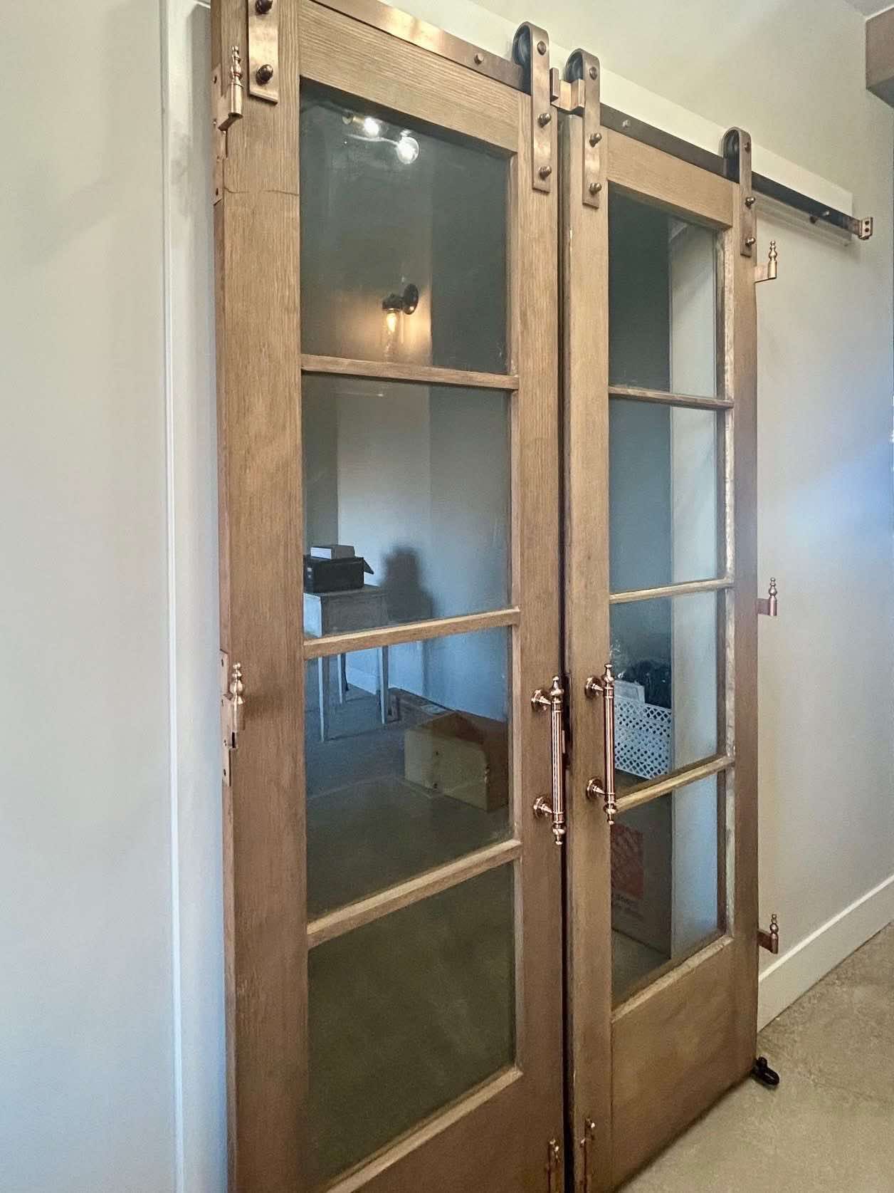 A pair of sliding glass doors from New Orleans leading into the master suite.