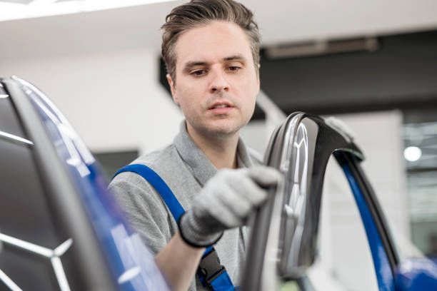 A man is working on a car in a garage.