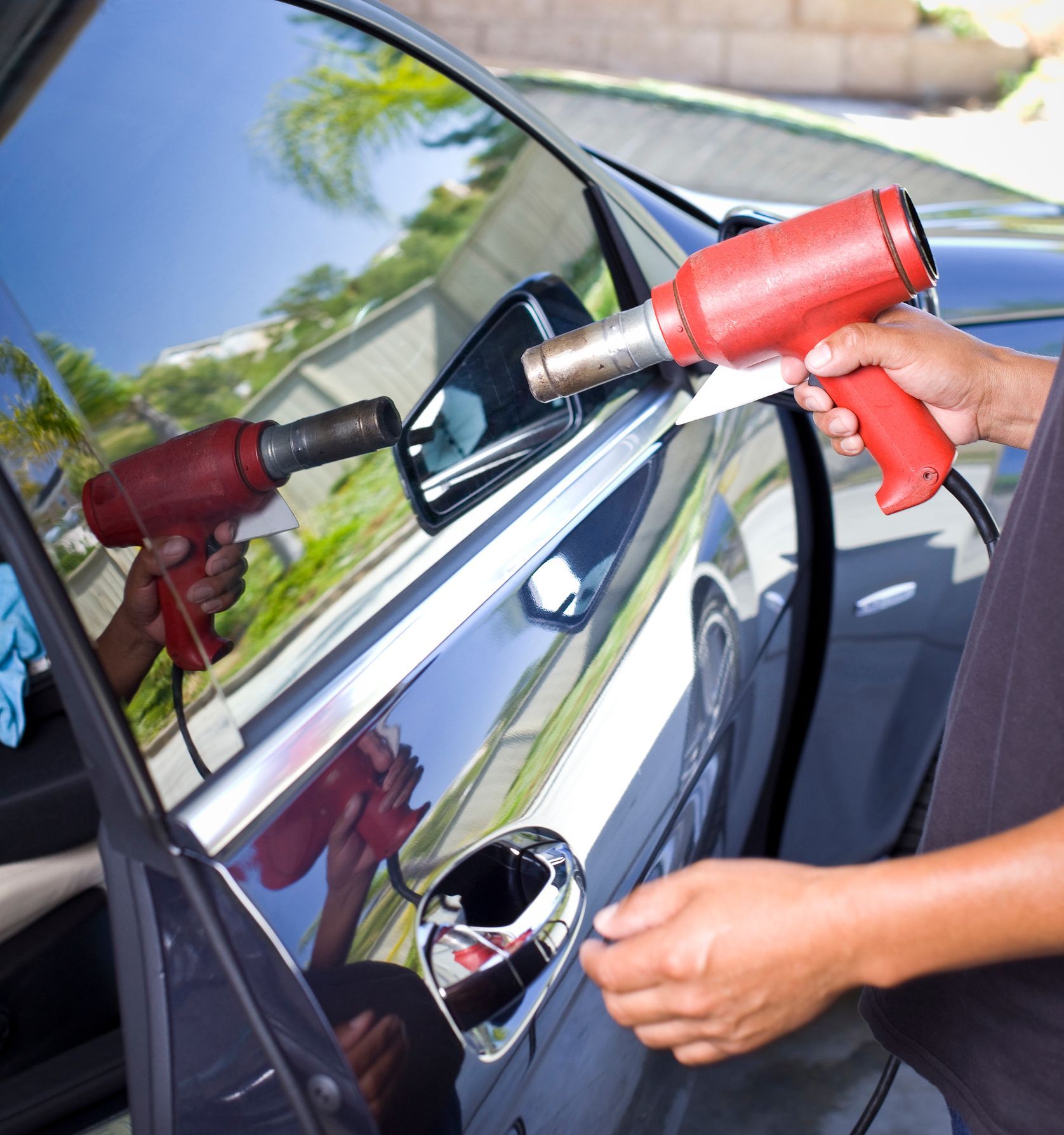 A person is applying tinted window film.