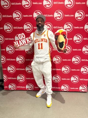 Person in Atlanta Hawks jersey holding a 