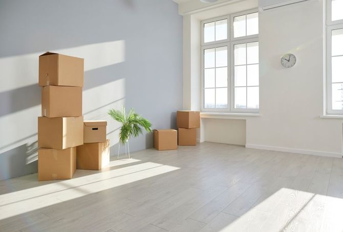 There are a lot of cardboard boxes in the room.