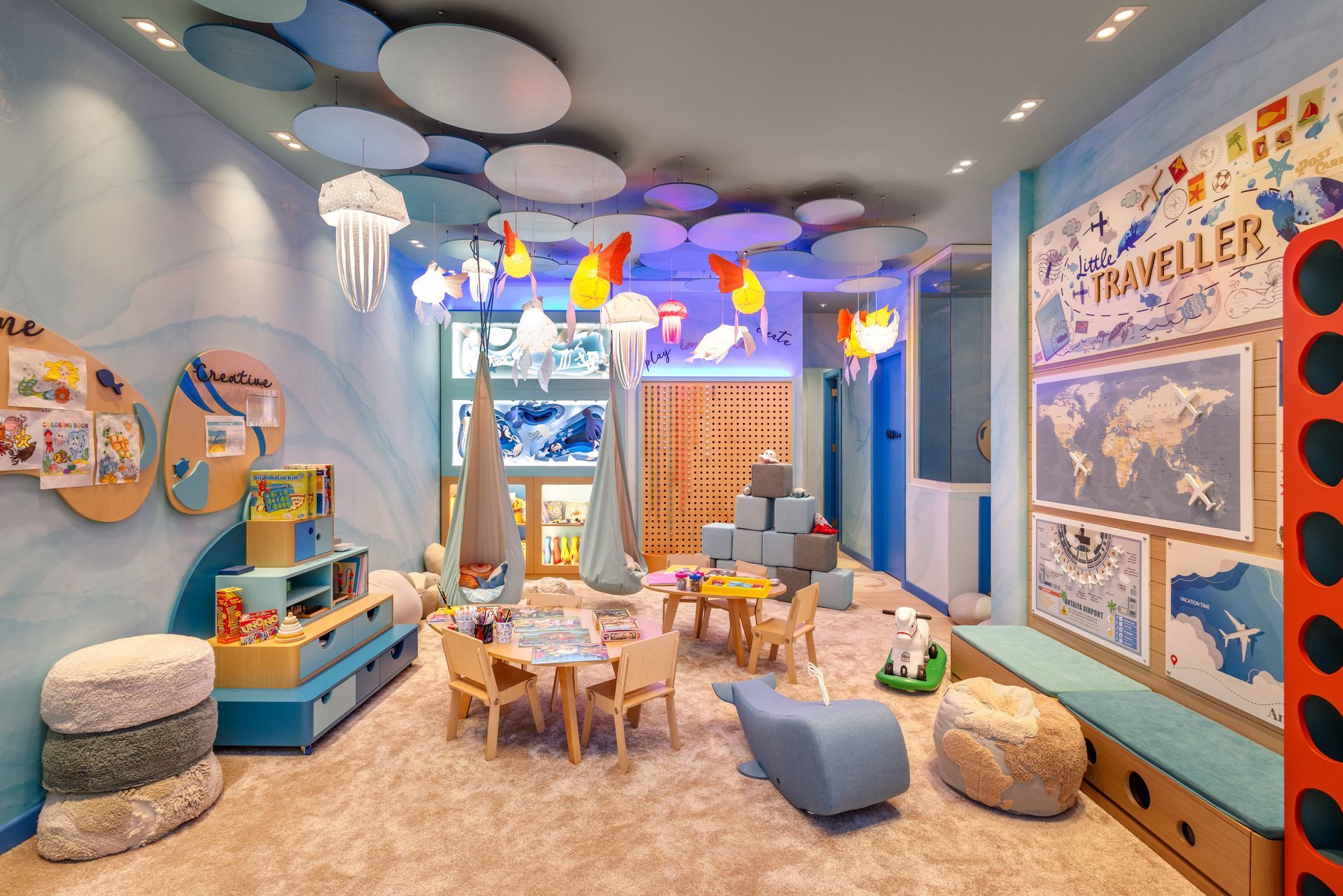 A children 's room with tables and chairs and a mural on the wall.