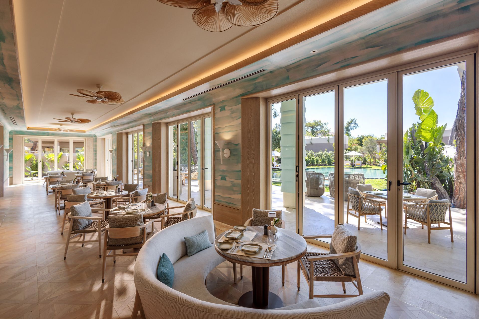 A large room with a lot of windows and tables and chairs.