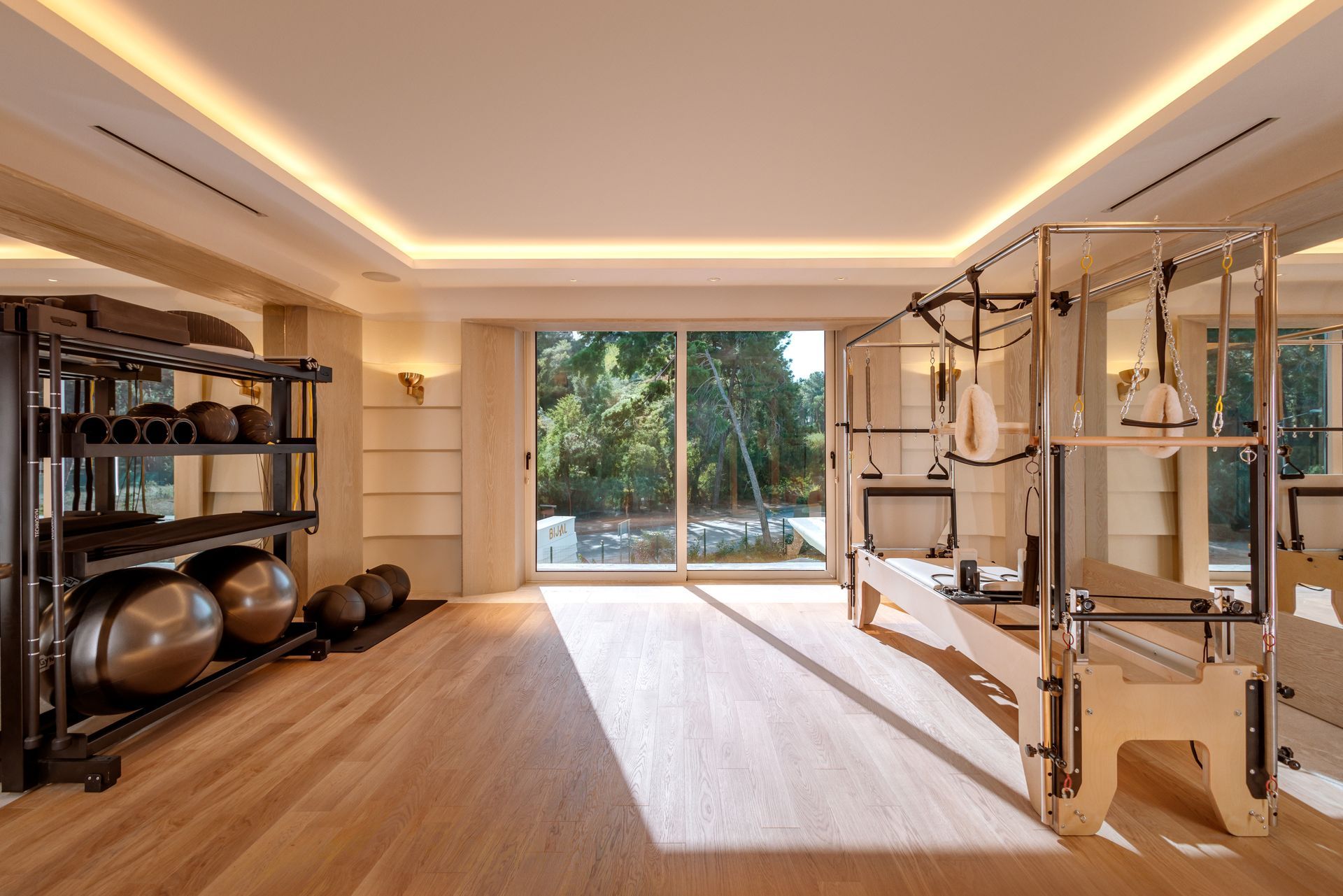 There is a pilates machine in the middle of the room.