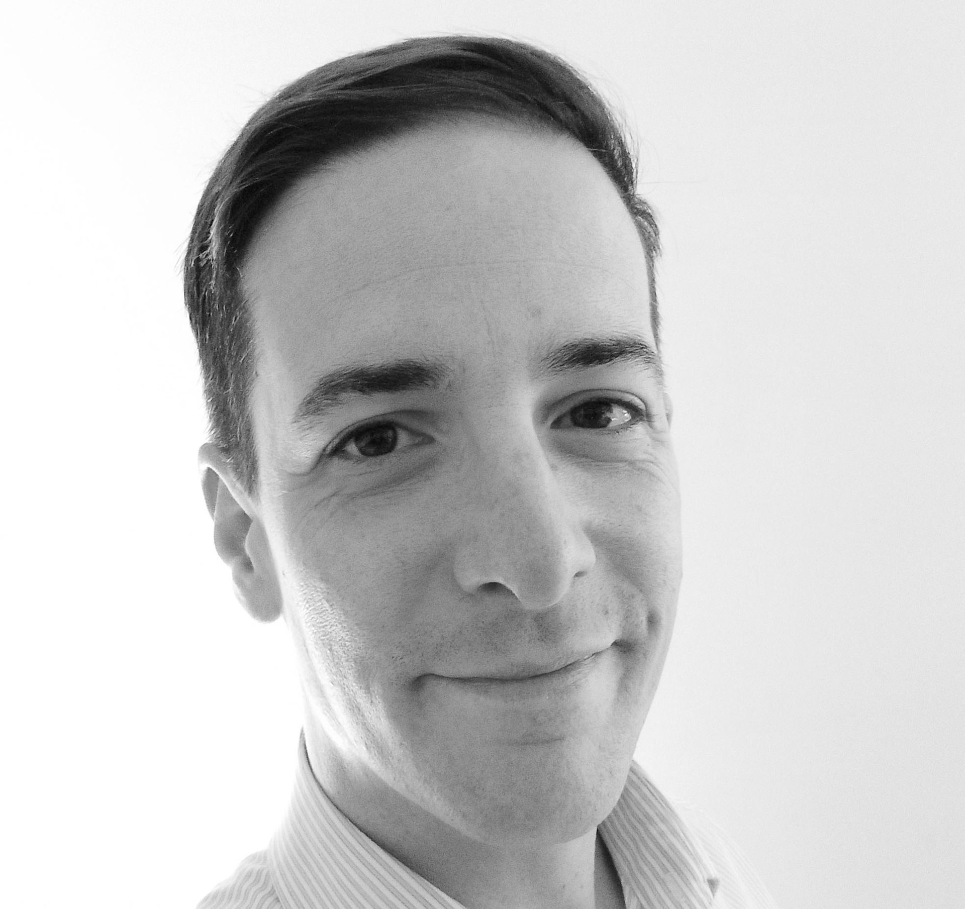 A man with a beard is wearing a suit and tie.