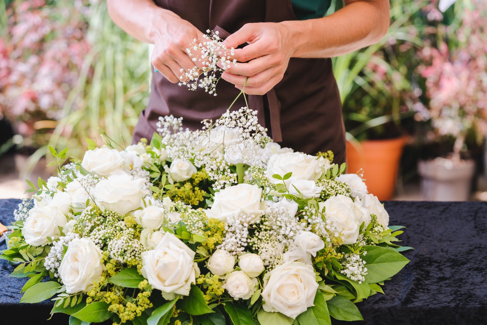 A florist is arranging a circular wreath. A florist is arranging a circular wreath.