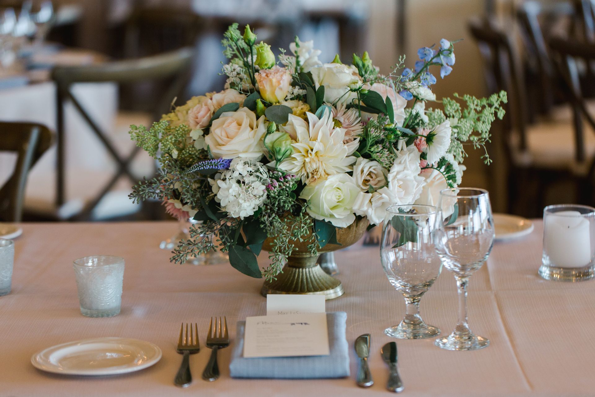 Elegant floral centerpiece on white tablecloth.