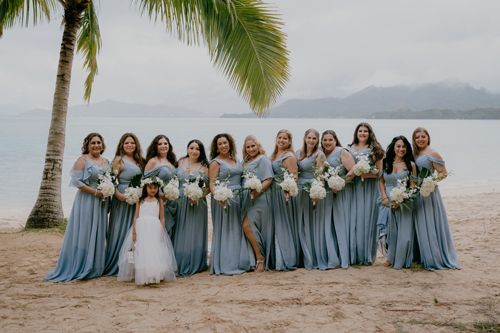A Bride And Her Bridesmaids Are Posing For A Picture On The Beach - Honolulu, HI - Bella Rosa Corporation