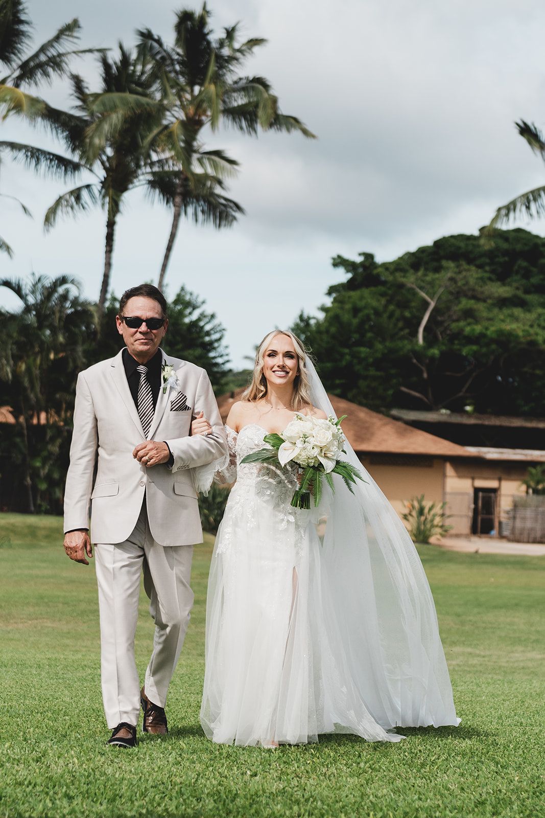 A Bride And Groom Are Walking Down The Aisle At Their Wedding - Honolulu, HI - Bella Rosa Corporation