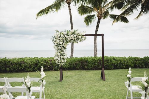 A Wedding Ceremony Is Taking Place In Front Of The Ocean - Honolulu, HI - Bella Rosa Corporation