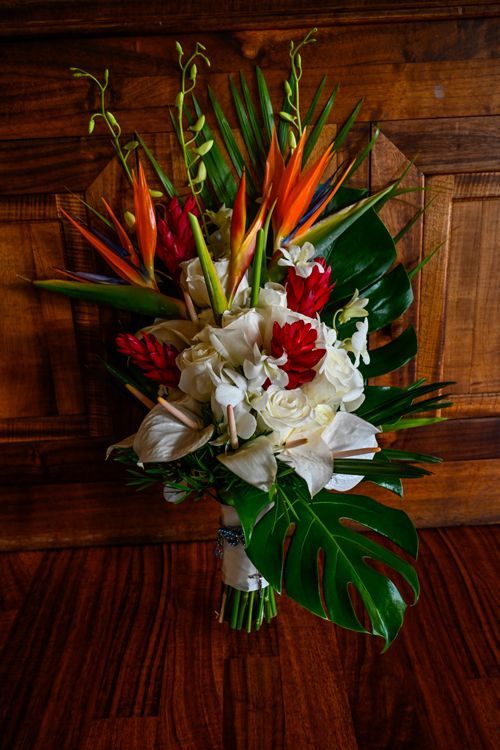 A Bouquet Of Tropical Flowers Is Sitting On A Wooden Floor - Honolulu, HI - Bella Rosa Corporation
