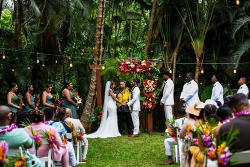 A Bride And Groom Are Getting Married In Front Of A Crowd Of People - Honolulu, HI - Bella Rosa Corporation