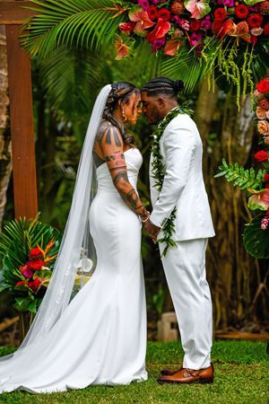 A Bride And Groom Are Holding Hands During Their Wedding Ceremony - Honolulu, HI - Bella Rosa Corporation