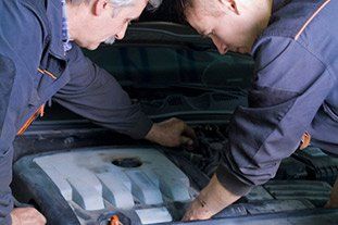 Auto Repair — Mechanic Changing Car in Wimberley TX