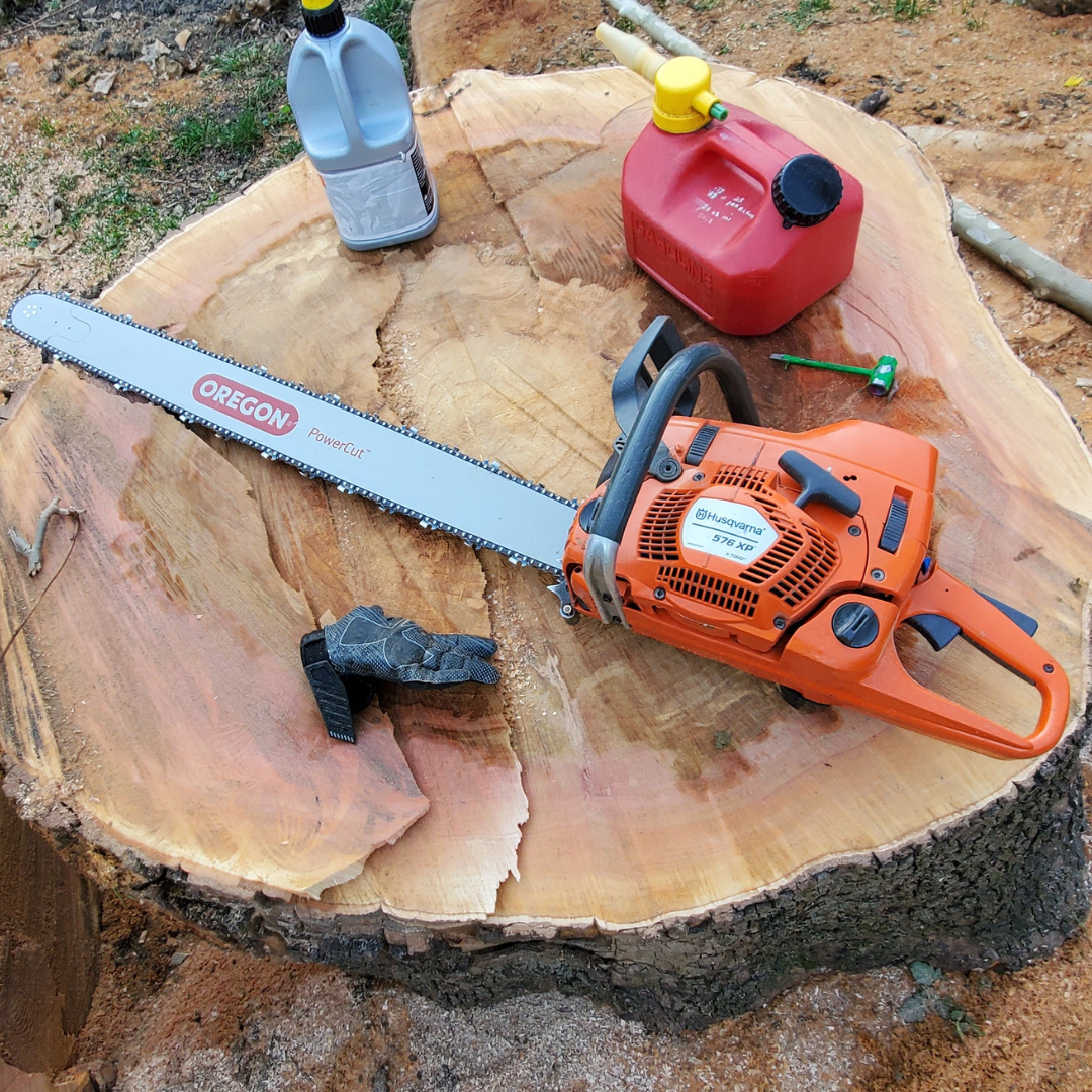 An oregon chainsaw is sitting on top of a tree stump