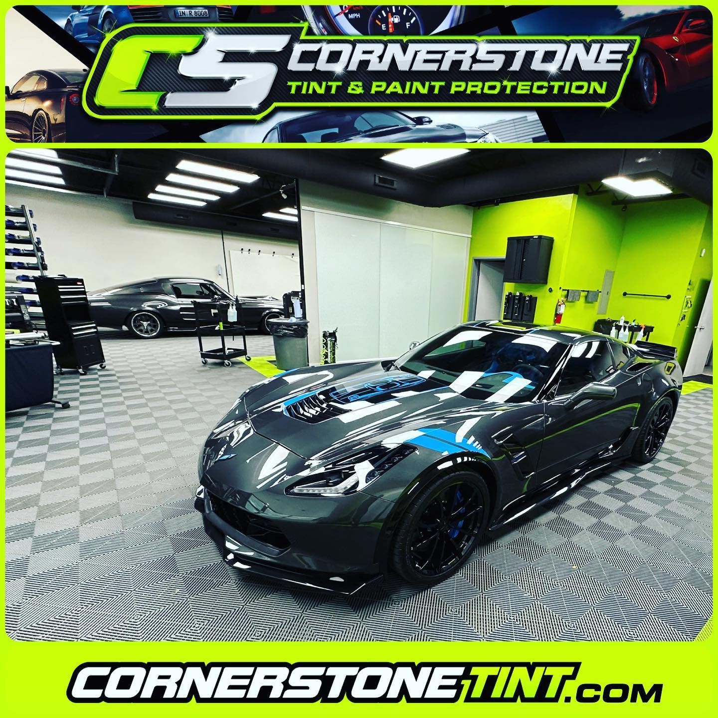 A gray sports car is parked in a garage.