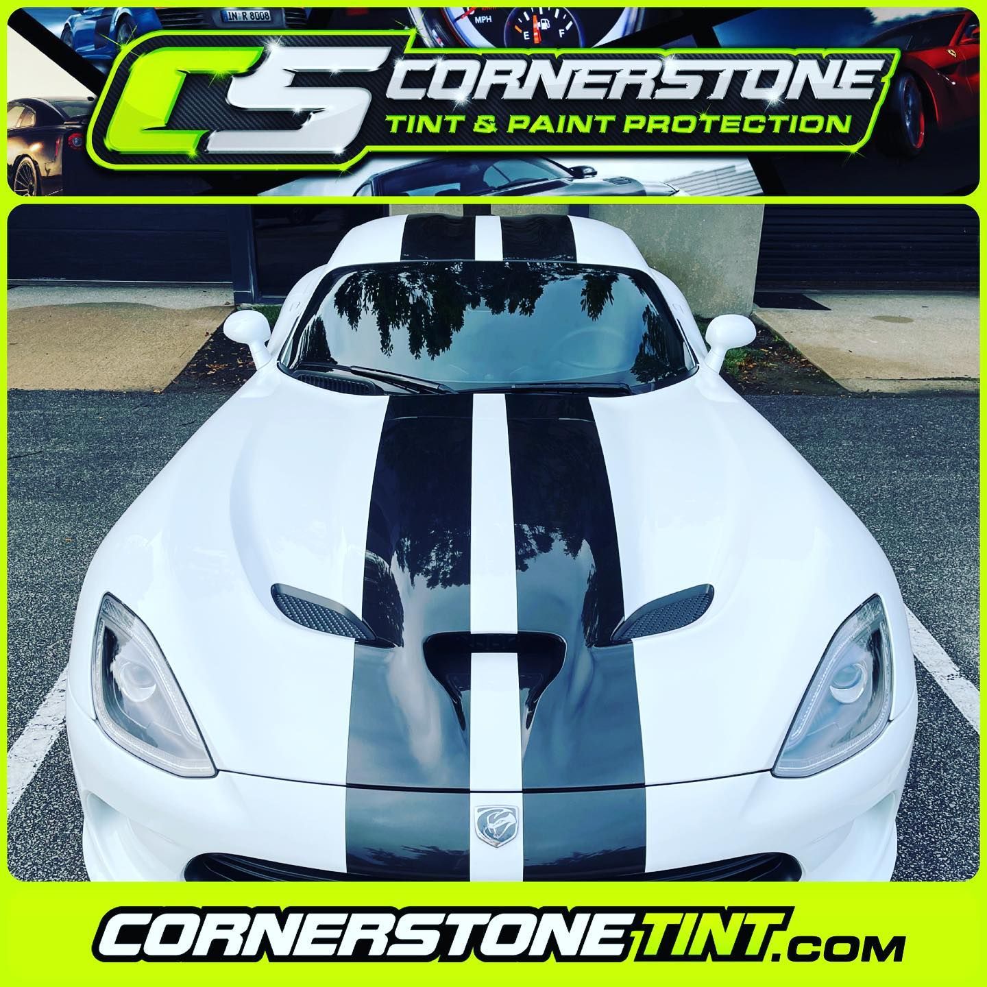 A white dodge viper with black stripes on the hood