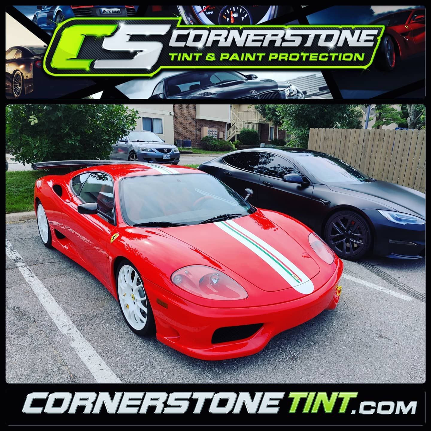 A red sports car is parked next to a black sports car