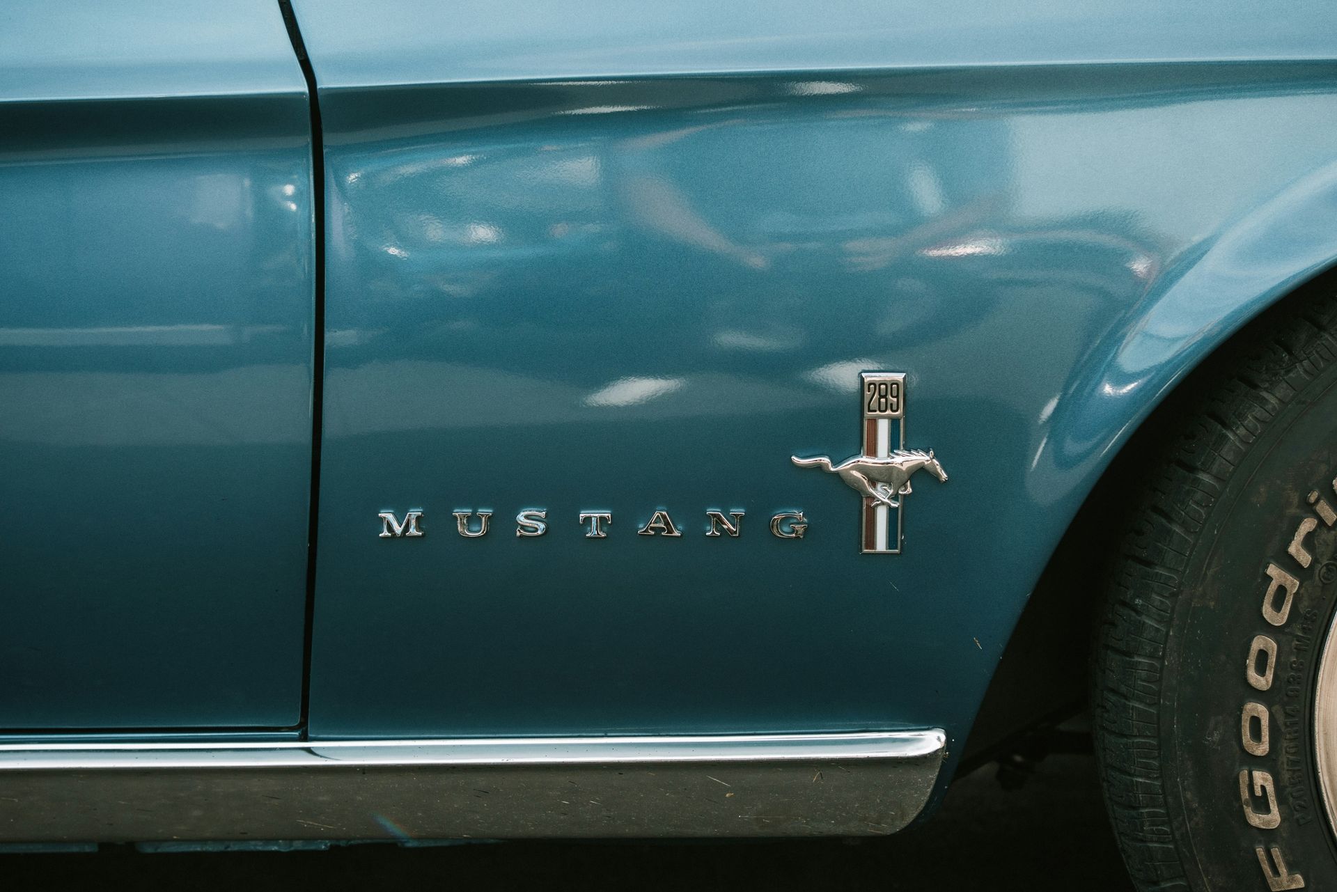 A blue mustang with a bfgoodrich tire on it