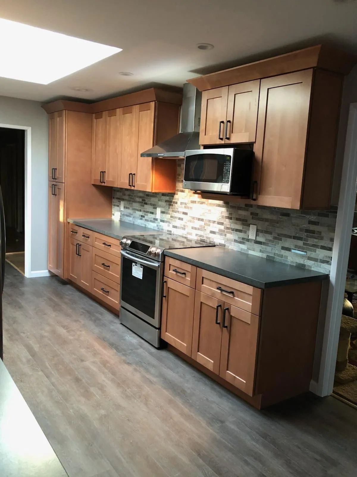 A kitchen with wooden cabinets and stainless steel appliances.