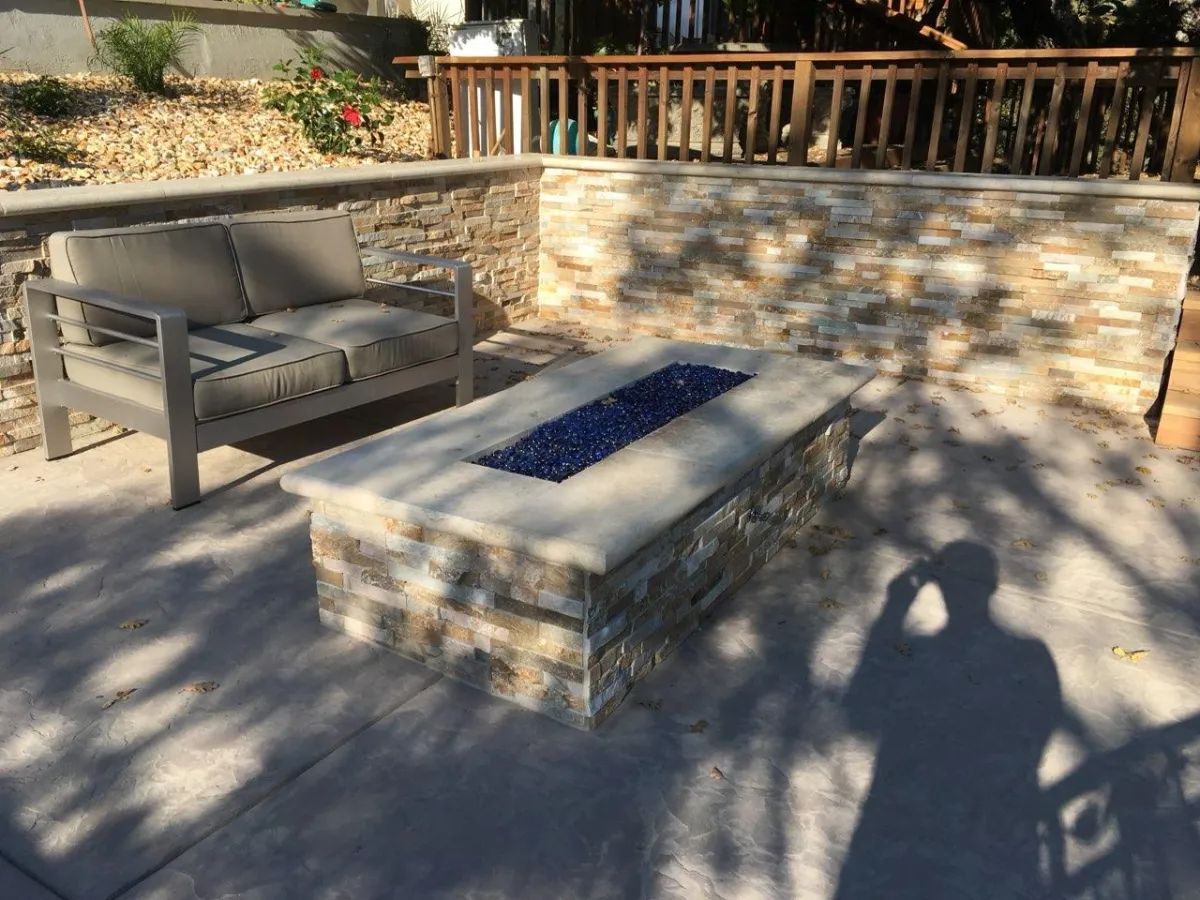 There is a fire pit in the middle of the patio.