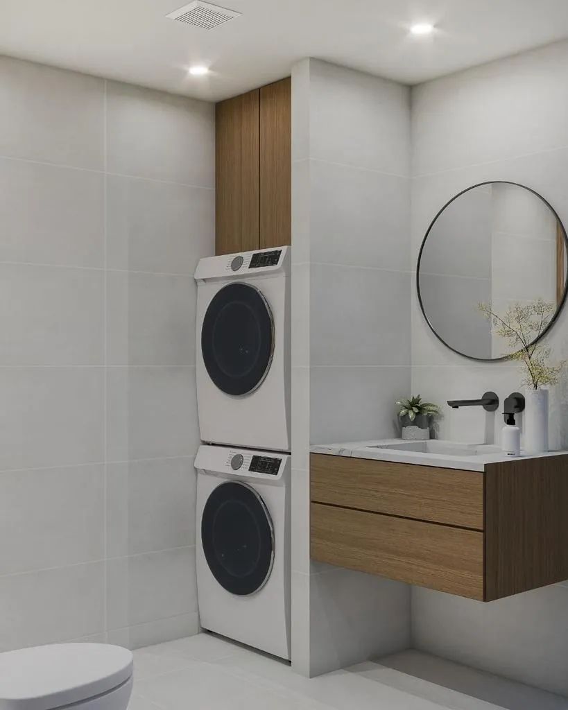 A bathroom with a washer and dryer stacked on top of each other.