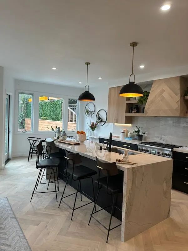 A kitchen with a large island and stools