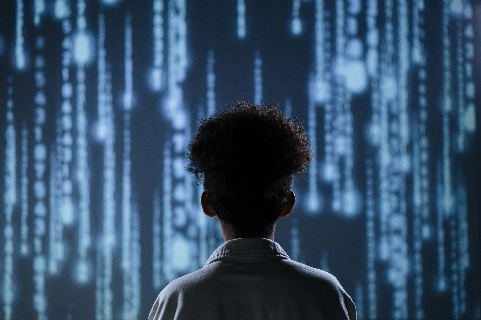 A woman with binary code projected on her face.