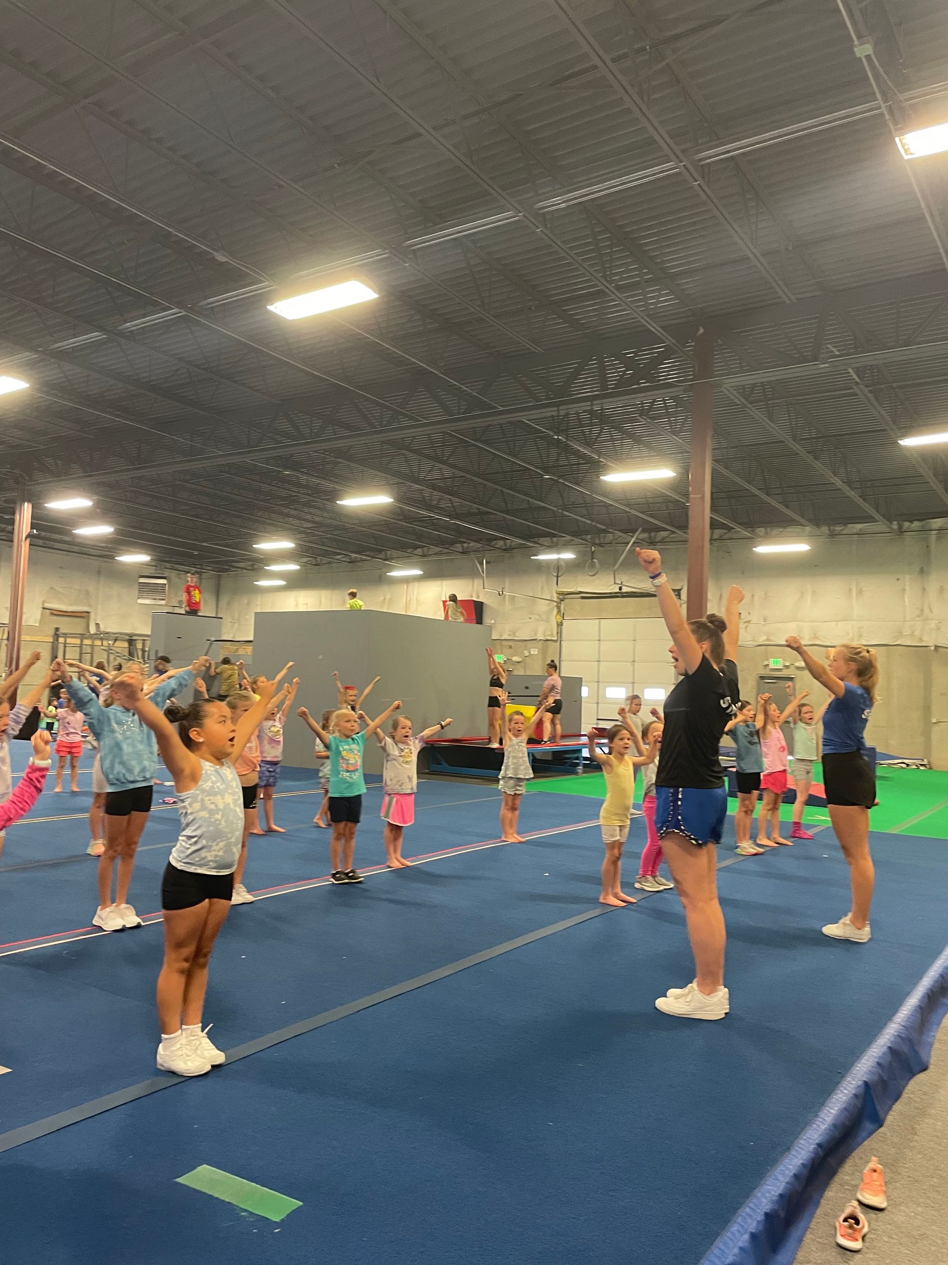 a group of young girls in a beginner cheer class