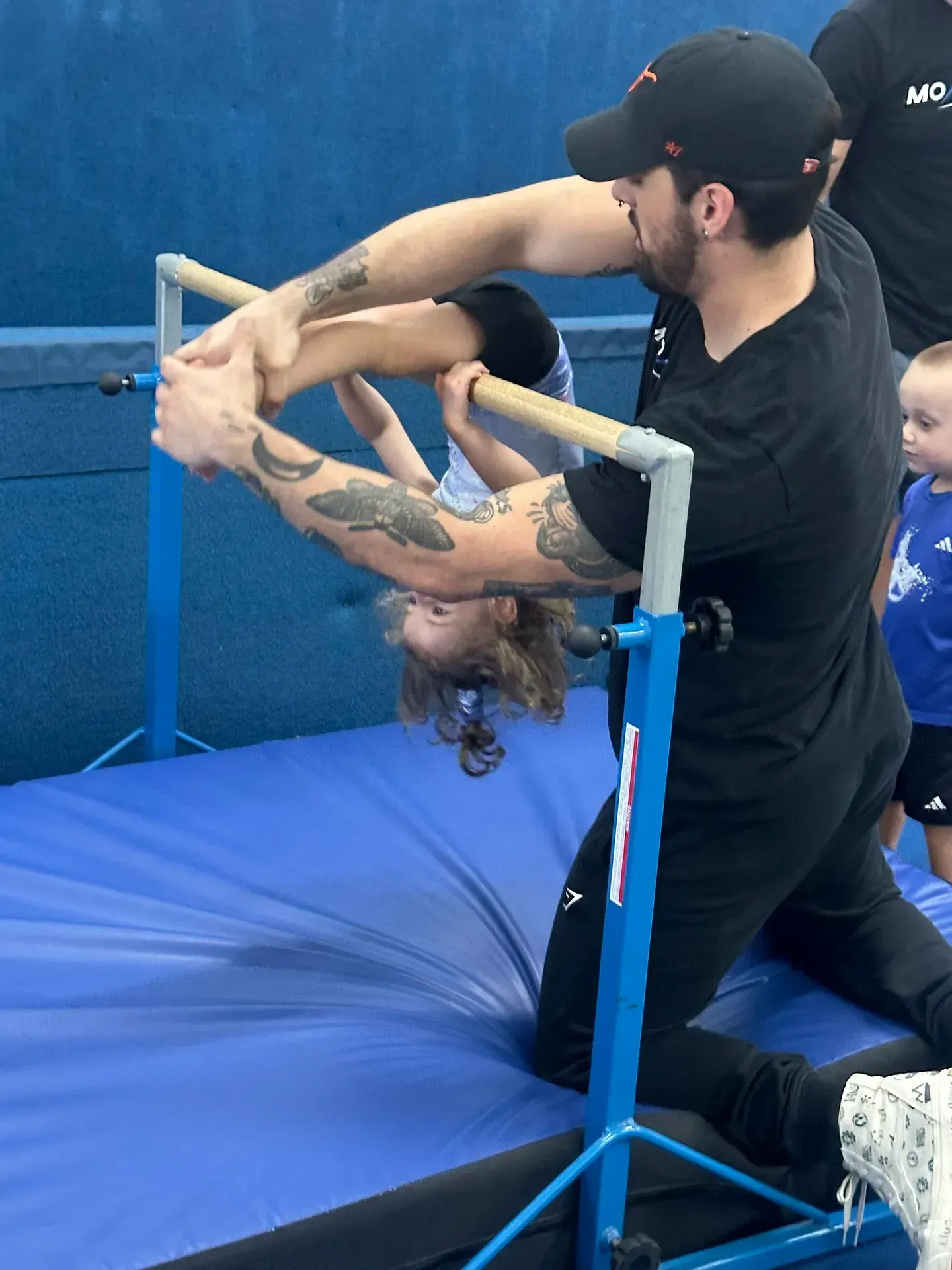 A special needs boy with autism being led by developmental pathways trained aids at Momentum Athletic Cnter