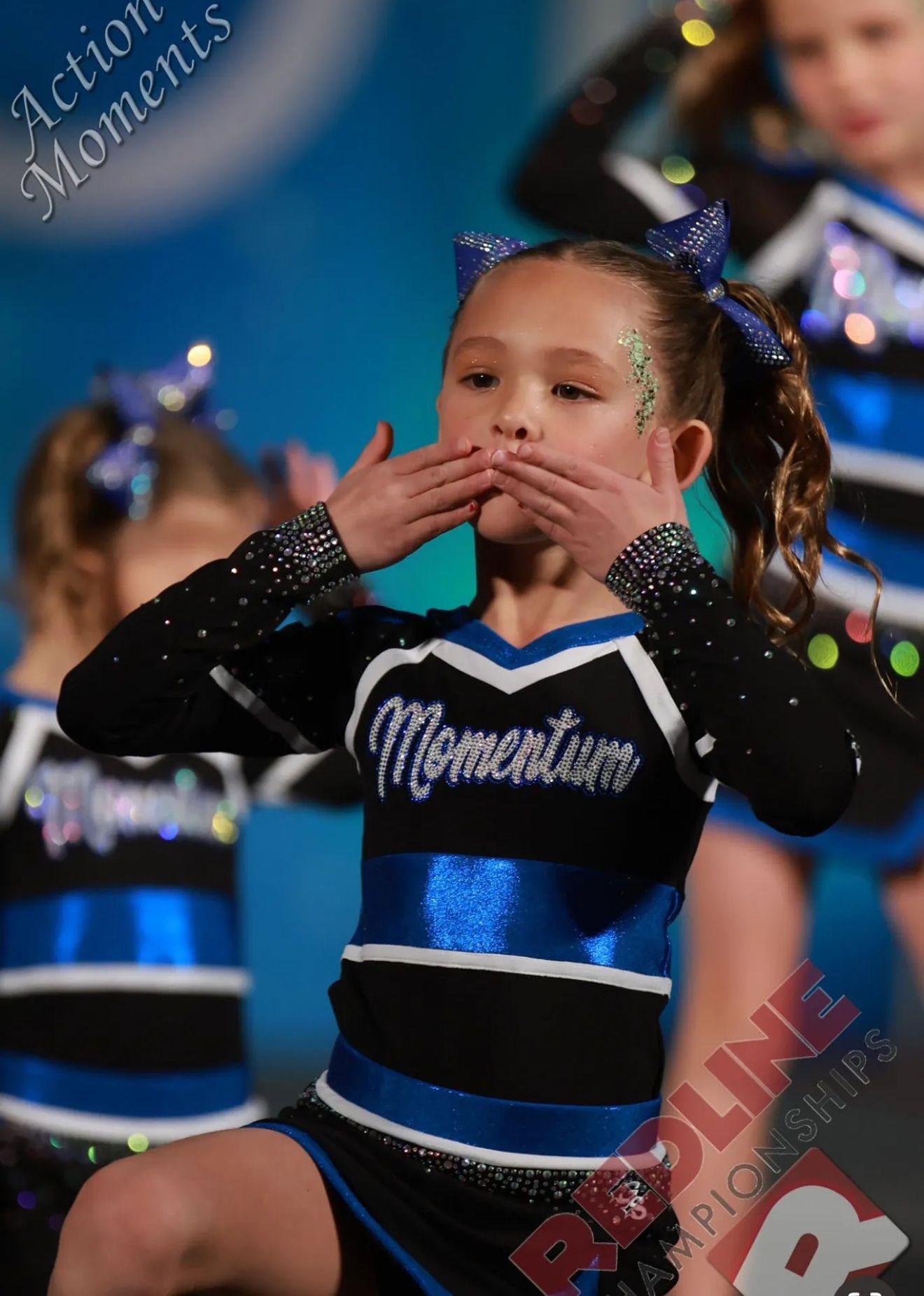 A cheerleader with the word momentum on her shirt