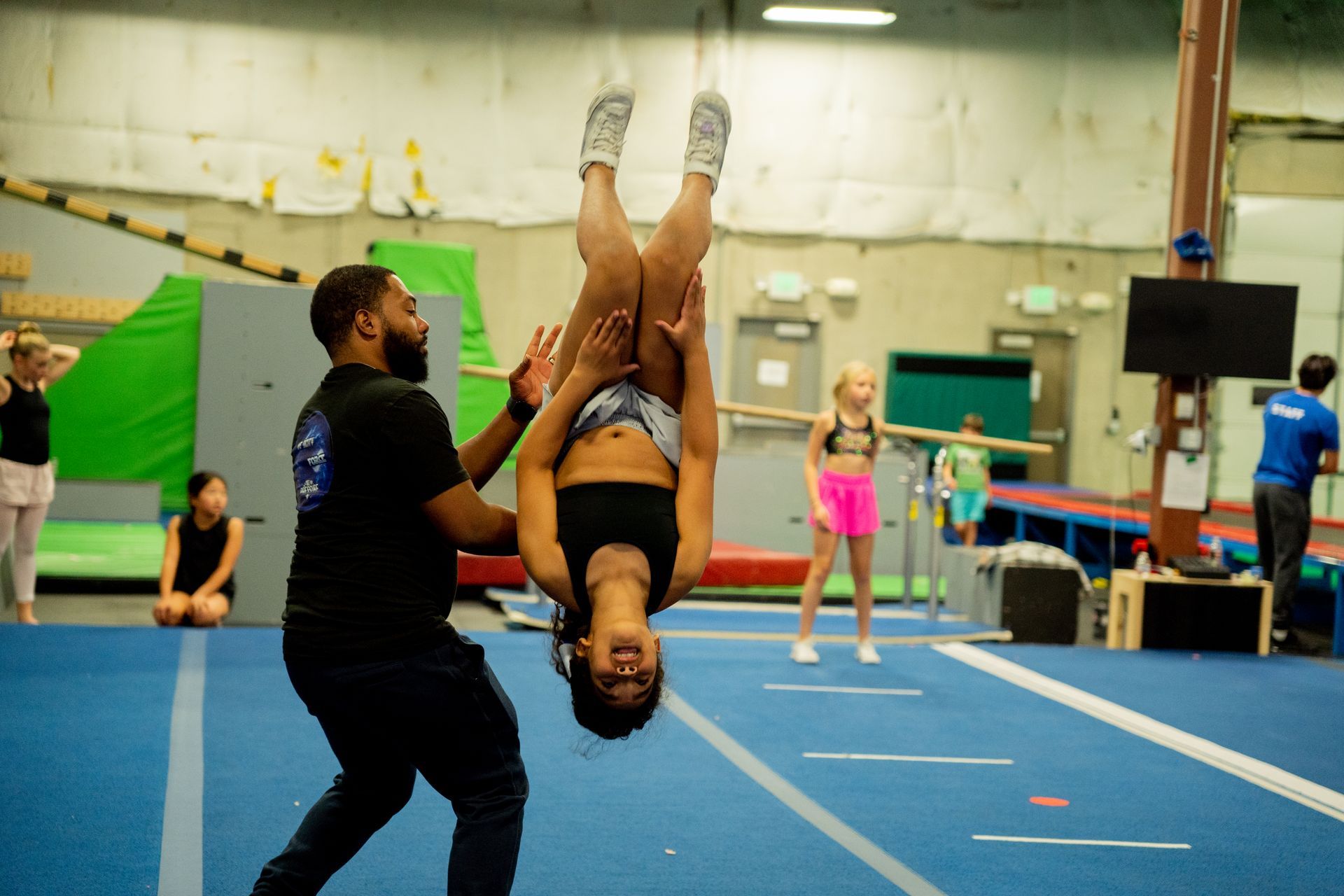 coach and student doing a flip