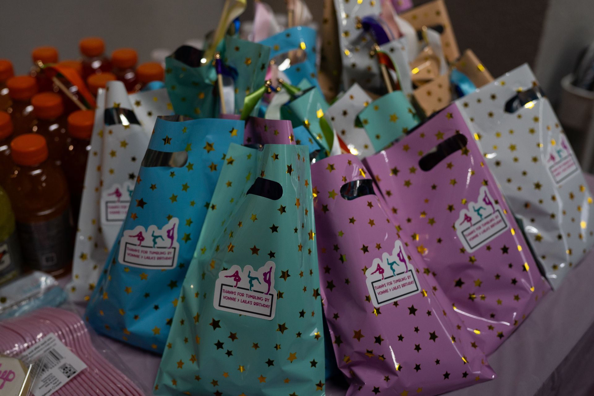 A bunch of birthday favor bags sitting on top of a table.