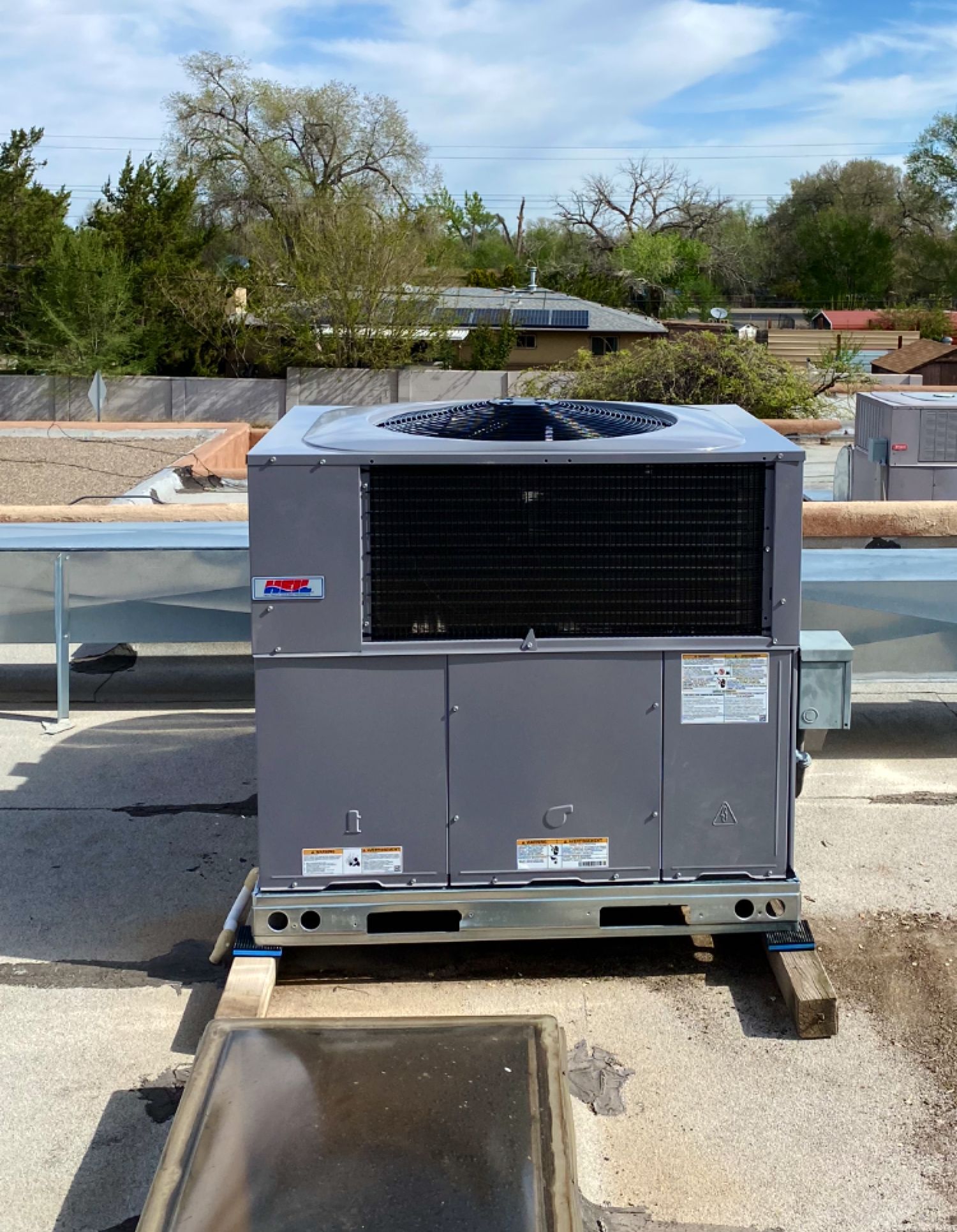 An air conditioner is sitting on the roof of a building