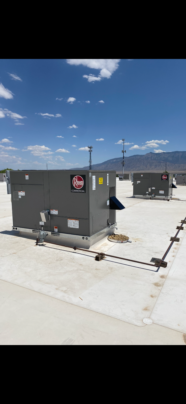 There are two buildings on the roof of a building.