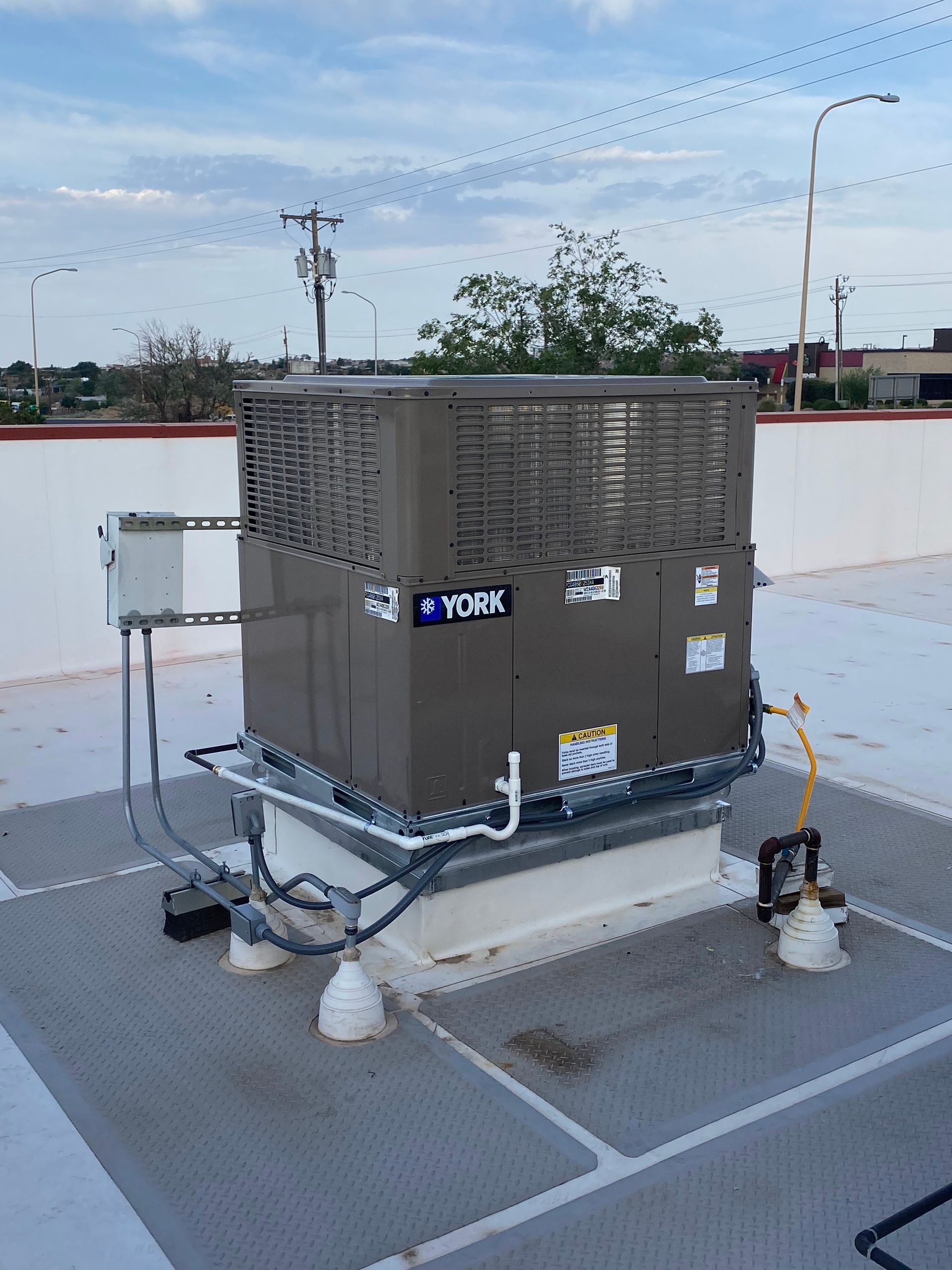 A york air conditioner is sitting on top of a roof.
