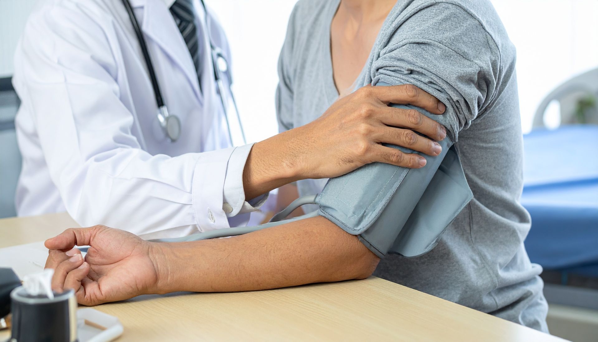 A dedicated primary healthcare provider attentively monitors a patient's blood pressure during 