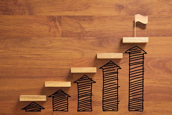 A wooden staircase with arrows and a flag on top of it.